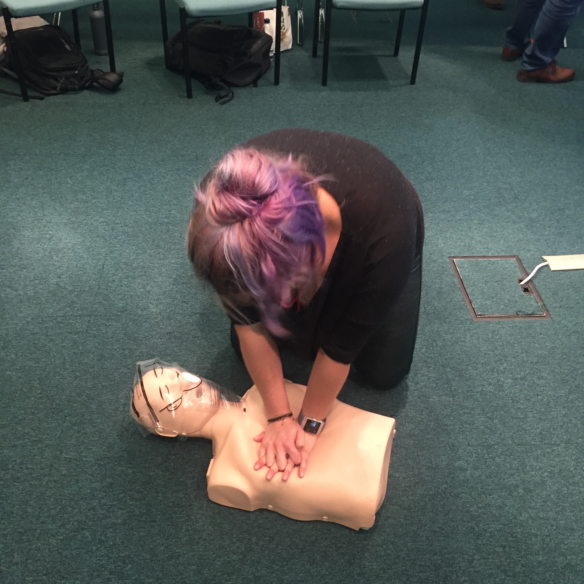 Jess simulating CPR at First Aid Training